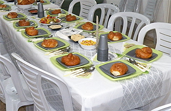 Tables are set and meals are served by volunteers from Lev LeZulat